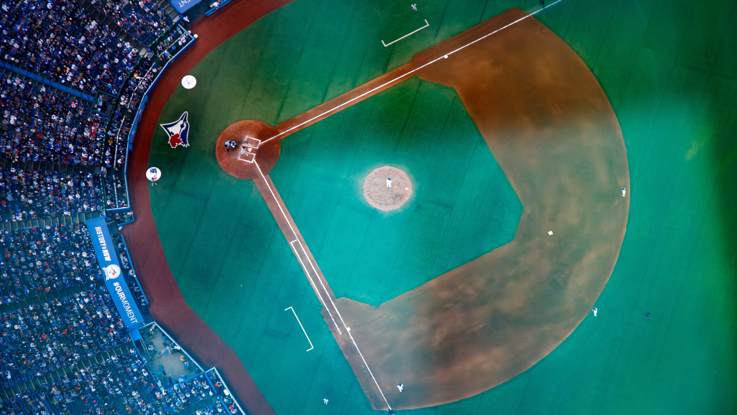 Aerial view of a baseball field and surrounding crowd.